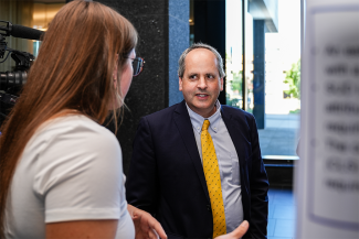 NIGMS Director Jon Lorsch talks with trainees at the poster session.