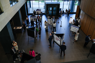 In the atrium of HKRB, 17 NIH-funded trainees presented posters for the NIH delegation.