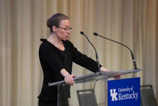 Sylvie Garneau-Tsodikova (Associate Vice President for Research) welcomes the crowd to the Celebrating University Research Across the Enterprise (CURATE) program.