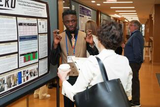 Symposium participants view trainee posters.