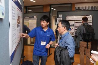 Symposium participants view trainee posters