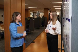 Symposium participants view trainee posters.