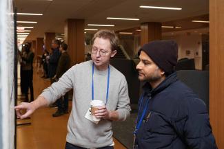 Symposium participants view trainee posters.