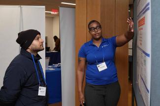 Symposium participants view trainee posters.