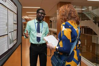 Symposium participants view trainee posters.