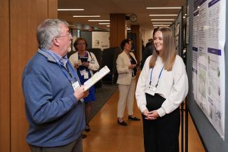 Symposium participants view trainee posters.