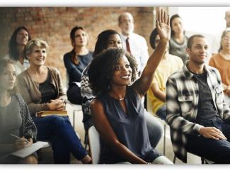 woman in crowd raising hand